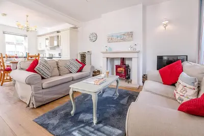 a living room with two couches and a table at Longshore, Aldeburgh in Aldeburgh