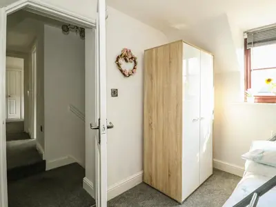 a room with a closet and a door at Chalk Cottage in Thetford