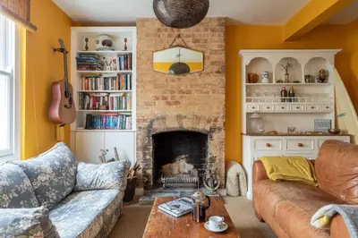 a living room with a couch and a fireplace at Lovely Central Cambridge Home in Cambridge