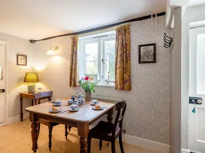 a dining room with a table and a window at Little Crown in Winfarthing