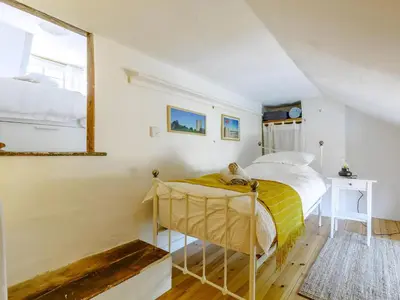 a bedroom with a bed and a window at Angel Lane in Woodbridge