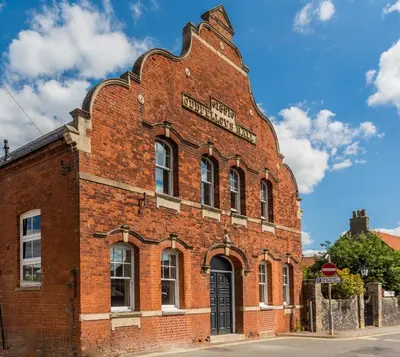 a red brick building with a sign on it at Oddfellows Hall in Thetford