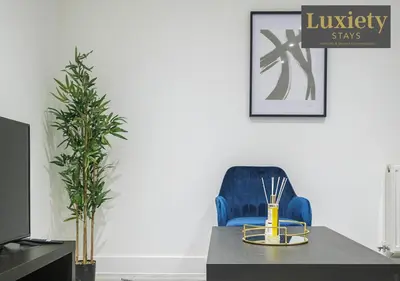 a dining room with a table and a blue chair at Stylish 1BR By Luxiety Stays Short Lets & Serviced Accommodation Southend on sea - Near High St & Southend Beach in Southend-on-Sea