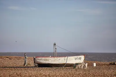 a boat sitting on top of a beach at SEALOFT, Aldeburgh , Stay in Suffolk in Aldeburgh
