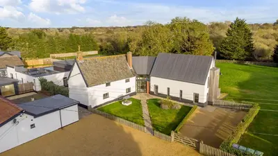 an aerial view of a white house with a yard at 5 Bedroom House in Larling, near Thetford in Norwich