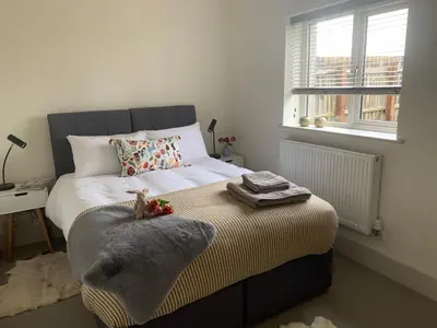 a bedroom with a bed with a teddy bear sitting on it at Oak Cottage at Gravel Farm in Stretham