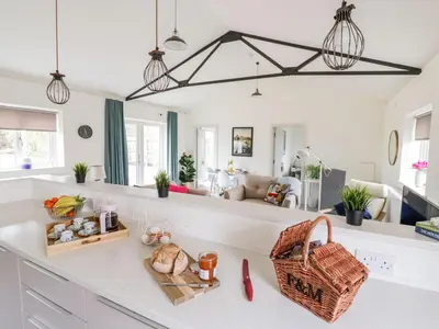 a kitchen with a white counter top with a basket at Oak Cottage at Gravel Farm in Stretham