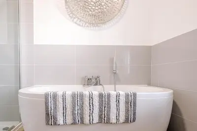 a bathroom with a white tub and a sink at 232a High Street, Aldeburgh in Aldeburgh