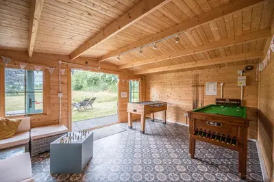 a room with a pool table in a wooden room at The Cartlodge Boundary Farm, Framlingham in Woodbridge