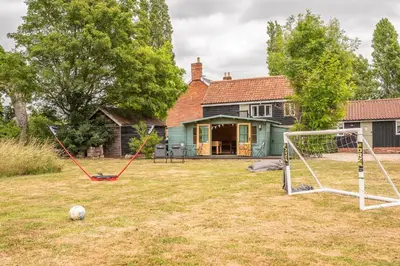 a yard with a soccer ball and a goal at Thyme Shepherds Hut Boundary Farm, Framlingham in Woodbridge
