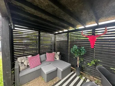 a person in a red dress is hanging on a patio at 2 Bedroom Garden Studio in Cambridge City Centre with Parking in Cambridge
