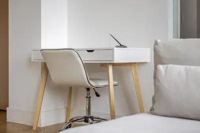 a white desk with a chair next to a bed at Luxury Parkway Apartment in Chelmsford City in Chelmsford