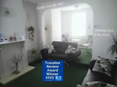 a living room with a couch and a chair at Victorian Terrace Old Stoke - With Self Check In and Free Parking - Rooms at ipswichdigs in Ipswich