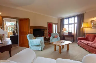 a living room with a couch and a table at Pounce Hall -Stunning historic home in rural Essex in Saffron Walden