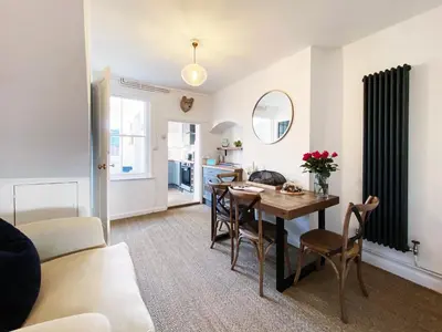 a living room and dining room with a table and chairs at 3 Chestnut Terrace by The Suffolk Cottage Collection in Long Melford
