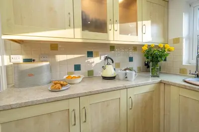 a kitchen counter with a plate of food on it at 4 The Birches - Aldeburgh Coastal Cottages in Aldeburgh