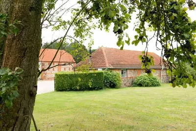 a house with a green yard in front of it at The Stables, relax in 5 star style and comfort with lovely walks all around in Great Maplestead