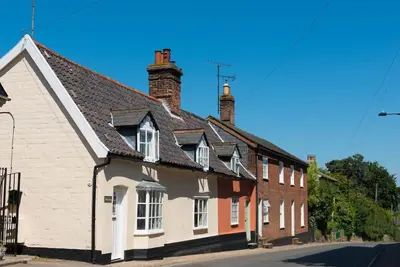 a group of houses on the side of a street at Wren Cottage, a very cosy historic Coastal Cottage in a pretty little village in Wickham Market