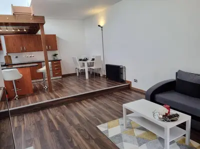 a living room with a couch and a table at Modern and spacious two bedroom apartment in Ipswich