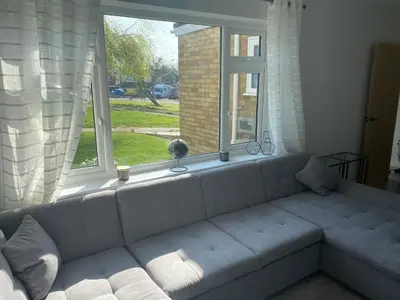 a couch in a living room with a window at •11 The Nook in Wivenhoe