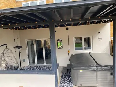 a patio with awning and a bed on a house at •11 The Nook in Wivenhoe