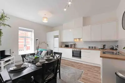 a kitchen and dining room with a table and chairs at Town center apartment in Bishops Stortford in Birchanger
