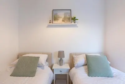 two beds sitting next to each other in a bedroom at Spacious Two Bed loft Apartment in Birchanger