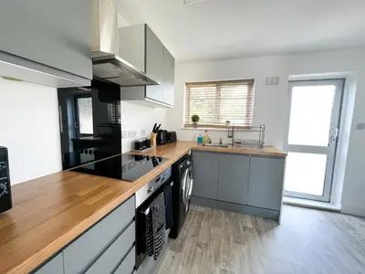 a kitchen with a counter and a stove top oven at Starview Apartment - Hawthorne in Colchester