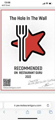 a sign that reads the hole in the wall recommended on restaurant curb at The Hole In The Wall in Little Wilbraham