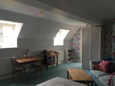 a living room with a couch and a table at Dragonfly Cottage, Rattlesden in Rattlesden