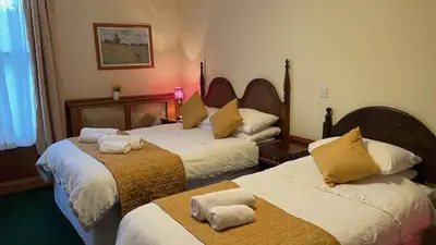 a hotel room with two beds with towels on them at Crown Hotel in Downham Market