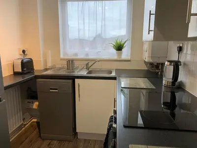 a small kitchen with a sink and a window at Modern Cosy Warm Home With Free Parking in Chelmsford