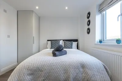 a bedroom with a bed with a blue towel on it at Townhouse for Professionals (5 Bedroom 5 Ensuite) in Ipswich