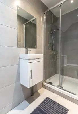 a bathroom with a shower and a white sink at Townhouse for Professionals (5 Bedroom 5 Ensuite) in Ipswich