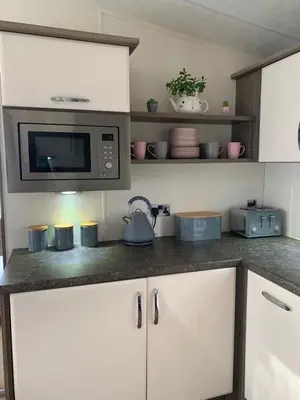 a kitchen with a counter top with a microwave at DaisyChain Getaways The perfect place to Stay Play and Getaway in East Mersea