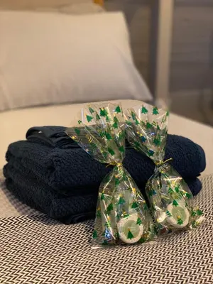 a pile of towels with a bow on a bed at Charming Annexe in a rural setting in Newton