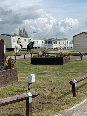 two people are riding horses in a field at DaisyChain 2 Getaways - The perfect place to Stay - Play - Getaway in East Mersea