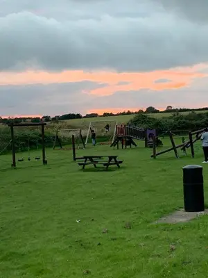 a group of picnic tables in a grass field at DaisyChain 2 Getaways - The perfect place to Stay - Play - Getaway in East Mersea