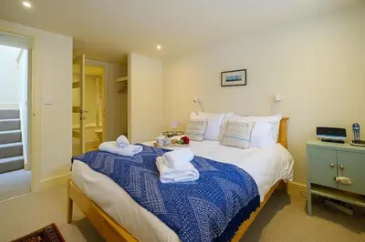 a bedroom with a bed with towels on it at Drake House in Aldeburgh