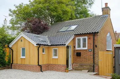 a small wooden house with a solar roof at Drake House in Aldeburgh