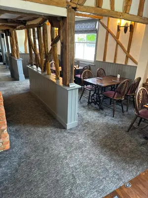 a dining room with tables and chairs in a building at The Fox Inn in Matching