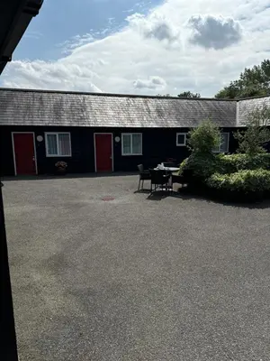 a black building with a table in front of it at The Fox Inn in Matching