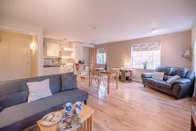 a living room with a couch and a table at The Woodshed, Benhall in Saxmundham
