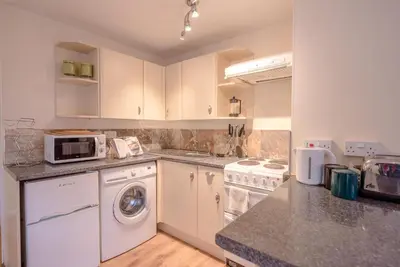 a kitchen with a washer and dryer at The Woodshed, Benhall in Saxmundham