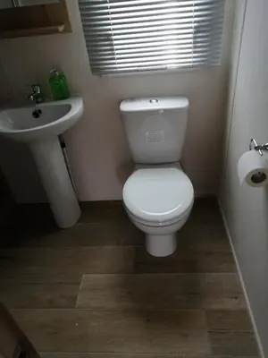 a bathroom with a white toilet and a sink at 709 Seawick in Jaywick Sands