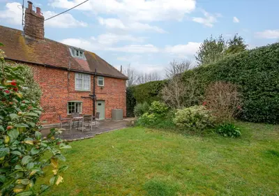 an old brick house with a yard in front of it at Appletree Cottage in Westleton