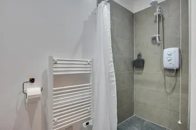 a bathroom with a shower with a shower curtain at 3 Bed in Great Waldingfield oc-ac2 in Great Waldingfield