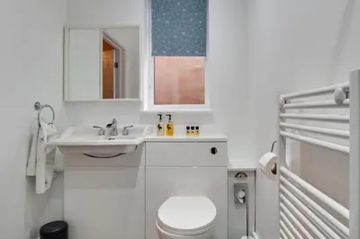 a white bathroom with a toilet and a sink at 3 Bed in Great Waldingfield oc-ac2 in Great Waldingfield