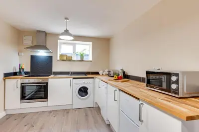 a kitchen with white appliances and a wooden counter top at 6 Bed in Great Waldingfield oc-ac4 in Great Waldingfield