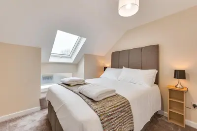 a bedroom with a large bed and a window at 2 Bed in Great Waldingfield oc-ac3 in Great Waldingfield
